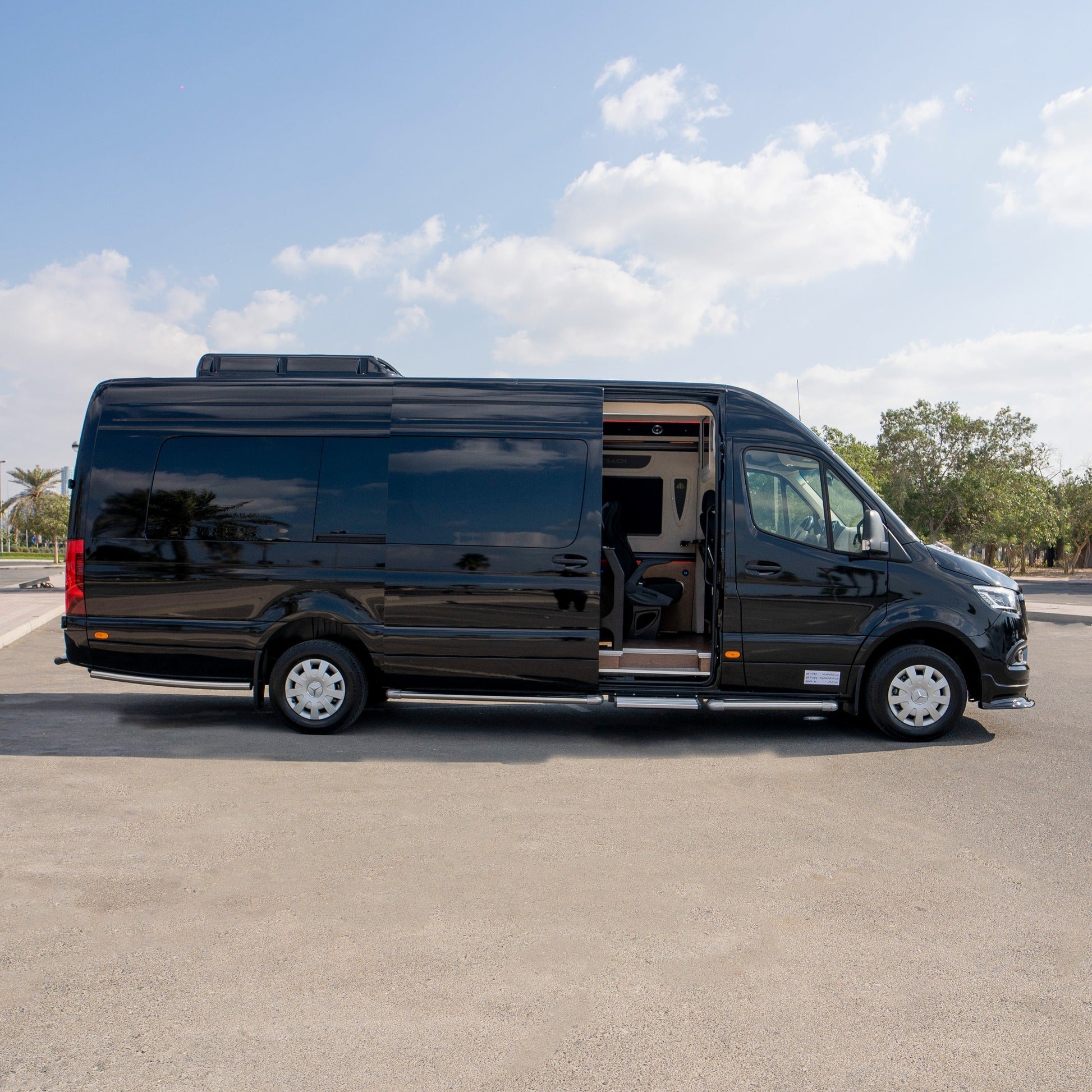 Side profile of Mercedes Maybach Sprinter 19-seater van parked in Dubai