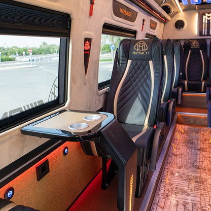 Table-angle view of luxury Maybach Sprinter 16-seater van interior