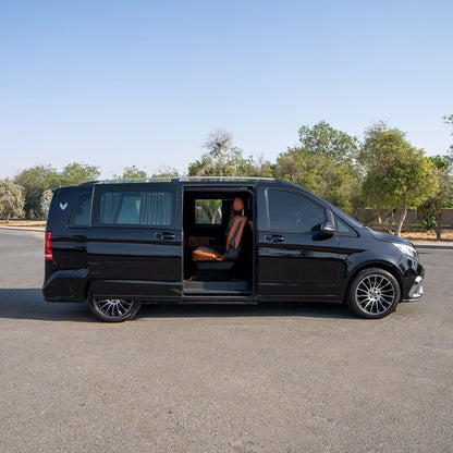 Side angle of V-Class Imperial van with chauffeur for royal transfer